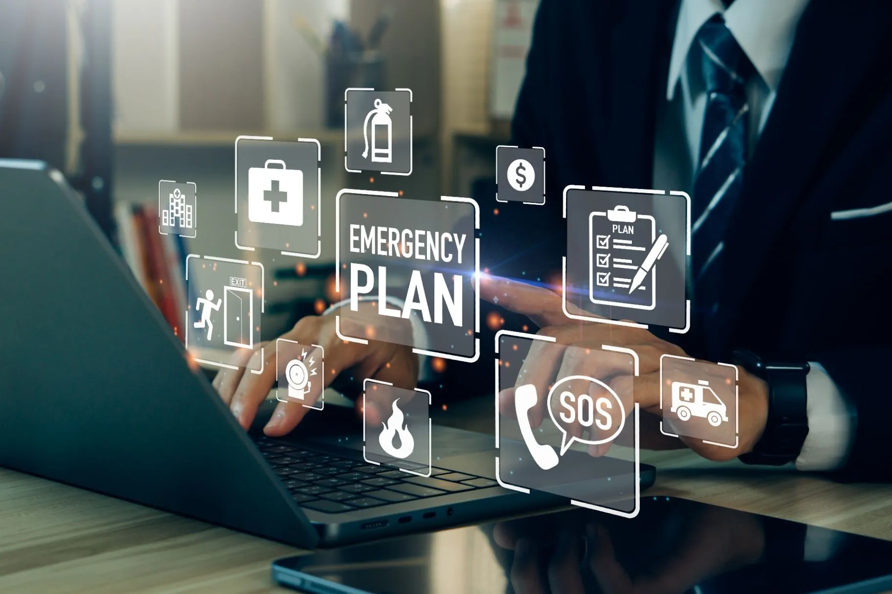Person working at a laptop with an emergency plan interface